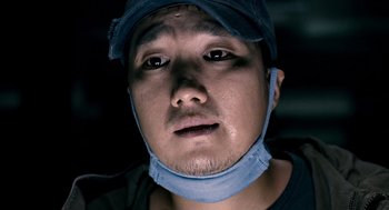 Movie still from “The Host” (2006), directed by Bong Joon Ho – A person wearing a surgical mask; Close Up shot, Low angle