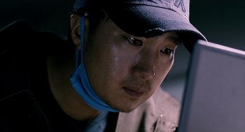 Movie still from “The Host” (2006), directed by Bong Joon Ho – A person wearing a hat; Close Up shot, Low angle