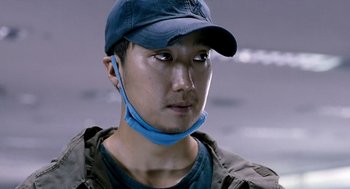 Movie still from “The Host” (2006), directed by Bong Joon Ho – A person wearing a hat; Close Up shot, Low angle