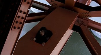 Movie still from “The Host” (2006), directed by Bong Joon Ho – A person is laying down on a slide; Wide shot, Overhead angle