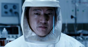 Movie still from “The Host” (2006), directed by Bong Joon Ho – A man in a white suit with a helmet on his head; Close Up shot, Low angle