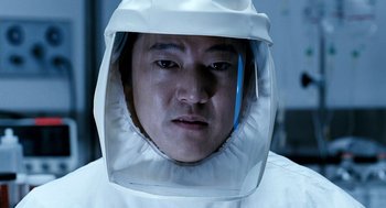 Movie still from “The Host” (2006), directed by Bong Joon Ho – A man wearing a white suit and a white helmet; Close Up shot, Low angle