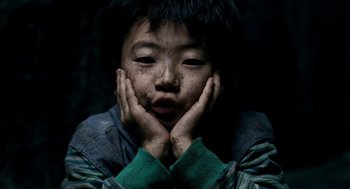 Movie still from “The Host” (2006), directed by Bong Joon Ho – A young boy with dirt on his face and hands; Close Up shot, Overhead angle