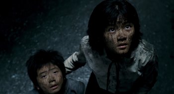 Movie still from “The Host” (2006), directed by Bong Joon Ho – Two young children are posing for a picture; Close Up shot, High angle
