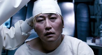 Movie still from “The Host” (2006), directed by Bong Joon Ho – A person with a bandage on their head; Close Up shot, High angle