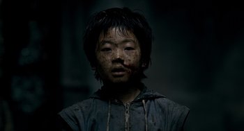 Movie still from “The Host” (2006), directed by Bong Joon Ho – A young boy is covered in dirt and mud; Close Up shot, Low angle