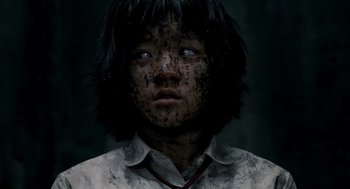 Movie still from “The Host” (2006), directed by Bong Joon Ho – A young person is looking into the camera; Close Up shot, High angle