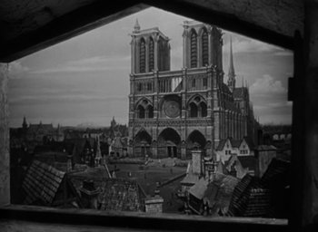 Movie still from “The Hunchback of Notre Dame” (1939), directed by William Dieterle – An old photo of an old church with a clock tower; Extreme Wide shot, Low angle
