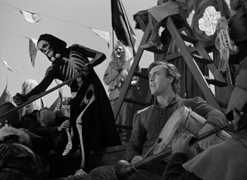 Movie still from “The Hunchback of Notre Dame” (1939), directed by William Dieterle – A group of people dressed up in costumes; Medium shot, Over the shoulder angle
