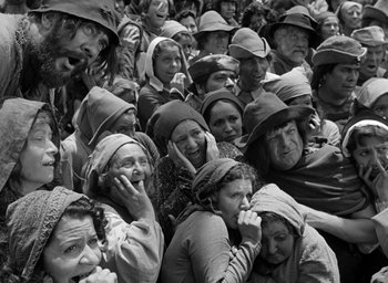 Movie still from “The Hunchback of Notre Dame” (1939), directed by William Dieterle – A group of people in a crowd wearing hats; Wide shot, High angle
