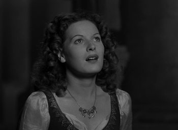 Movie still from “The Hunchback of Notre Dame” (1939), directed by William Dieterle – A black and white photo of a woman looking up; Close Up shot, Low angle