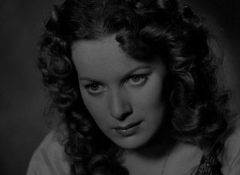 Movie still from “The Hunchback of Notre Dame” (1939), directed by William Dieterle – A black and white photo of a woman with curly hair; Close Up shot, High angle