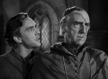 Movie still from “The Hunchback of Notre Dame” (1939), directed by William Dieterle – A man and a man in a black and white photo; Close Up shot, Low angle