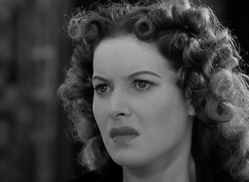 Movie still from “The Hunchback of Notre Dame” (1939), directed by William Dieterle – A black and white photo of a woman with curly hair; Close Up shot, Over the shoulder angle