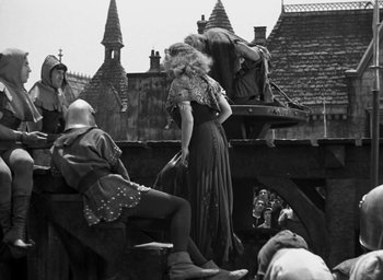Movie still from “The Hunchback of Notre Dame” (1939), directed by William Dieterle – A group of people standing on top of a building; Wide shot, Low angle
