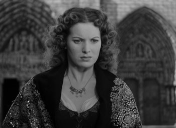 Movie still from “The Hunchback of Notre Dame” (1939), directed by William Dieterle – A black and white photo of a woman with curly red hair; Close Up shot, Low angle