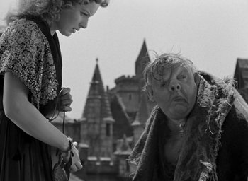 Movie still from “The Hunchback of Notre Dame” (1939), directed by William Dieterle – An old photo of a woman looking at a man; Medium shot, Low angle