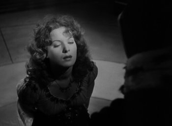 Movie still from “The Hunchback of Notre Dame” (1939), directed by William Dieterle – A black - and - white photo of a woman in a black dress; Close Up shot, Over the shoulder angle