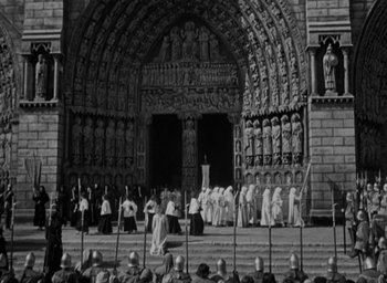 Movie still from “The Hunchback of Notre Dame” (1939), directed by William Dieterle – Black and white photograph of people standing in front of a building; Extreme Wide shot, High angle