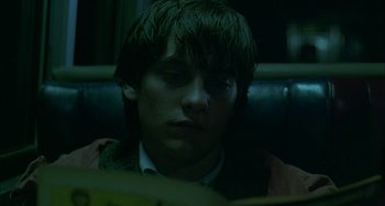 Movie still from “The Ice Storm” (1997), directed by Ang Lee – A man sitting in a chair looking at a computer screen; Close Up shot, Low angle