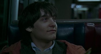 Movie still from “The Ice Storm” (1997), directed by Ang Lee – A young man sitting in a chair looking up; Close Up shot, Low angle