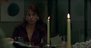 Movie still from “The Ice Storm” (1997), directed by Ang Lee – A woman sitting at a dinner table with candles in front of her; Close Up shot, Over the shoulder angle