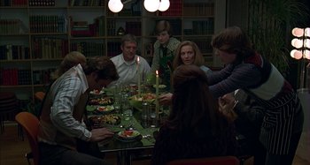 Movie still from “The Ice Storm” (1997), directed by Ang Lee – A group of people sitting around a dinner table; Medium shot, High angle