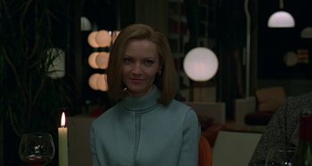 Movie still from “The Ice Storm” (1997), directed by Ang Lee – A woman in a blue sweater posing for a picture; Close Up shot, Low angle