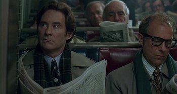 Movie still from “The Ice Storm” (1997), directed by Ang Lee – A group of men sitting on a train reading newspapers; Close Up shot, Over the shoulder angle