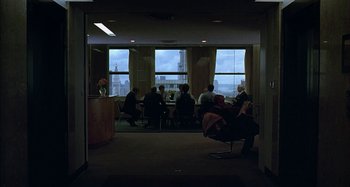 Movie still from “The Ice Storm” (1997), directed by Ang Lee – A group of people sitting at a table in front of a window; Extreme Wide shot, High angle