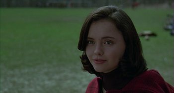 Movie still from “The Ice Storm” (1997), directed by Ang Lee – A young woman in a red jacket is looking at the camera; Close Up shot, Over the shoulder angle