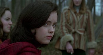 Movie still from “The Ice Storm” (1997), directed by Ang Lee – A young woman in a wooded area looking at the camera; Close Up shot, Over the shoulder angle