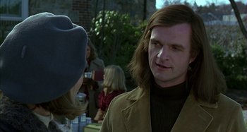 Movie still from “The Ice Storm” (1997), directed by Ang Lee – A man with long brown hair talking to a woman; Close Up shot, Over the shoulder angle