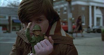 Movie still from “The Ice Storm” (1997), directed by Ang Lee – A young boy holding a toy soldier in front of his face; Close Up shot, Low angle