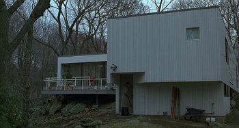 Movie still from “The Ice Storm” (1997), directed by Ang Lee – A person standing in front of a house; Extreme Wide shot, Low angle