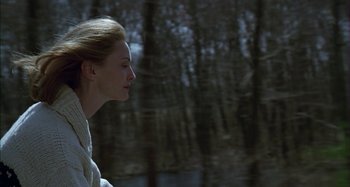 Movie still from “The Ice Storm” (1997), directed by Ang Lee – A young woman is standing in a wooded area; Close Up shot, Over the shoulder angle
