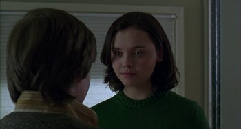 Movie still from “The Ice Storm” (1997), directed by Ang Lee – A young woman in a green sweater looking into a mirror; Close Up shot, Over the shoulder angle