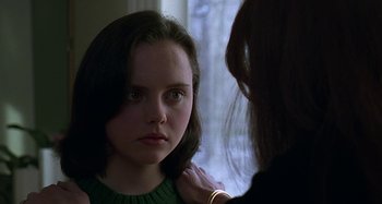 Movie still from “The Ice Storm” (1997), directed by Ang Lee – A woman looking into a mirror while holding her hand on her shoulder; Close Up shot, Over the shoulder angle