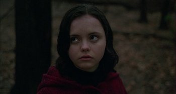 Movie still from “The Ice Storm” (1997), directed by Ang Lee – A young woman wearing a red jacket looking at the camera; Close Up shot, High angle