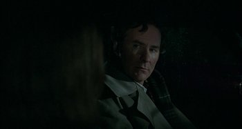 Movie still from “The Ice Storm” (1997), directed by Ang Lee – A man sitting in a car at night looking at the camera; Close Up shot, Over the shoulder angle