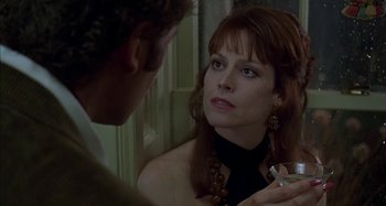 Movie still from “The Ice Storm” (1997), directed by Ang Lee – A woman looking into a mirror while holding a glass; Close Up shot, Over the shoulder angle