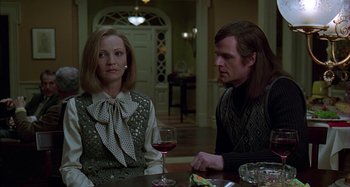 Movie still from “The Ice Storm” (1997), directed by Ang Lee – A man and a woman sitting at a table with a glass of red wine; Medium shot, Over the shoulder angle
