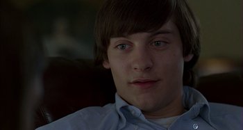 Movie still from “The Ice Storm” (1997), directed by Ang Lee – A person sitting in a chair; Close Up shot, Over the shoulder angle
