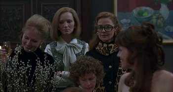 Movie still from “The Ice Storm” (1997), directed by Ang Lee – A group of women standing next to each other in a room; Medium shot, Over the shoulder angle