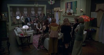 Movie still from “The Ice Storm” (1997), directed by Ang Lee – A group of people gathered in a living room; Wide shot, High angle