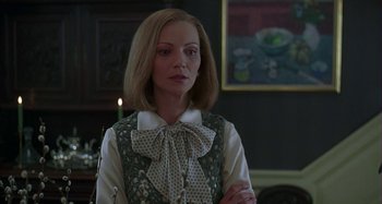 Movie still from “The Ice Storm” (1997), directed by Ang Lee – A woman in a green and white blouse standing in a room; Close Up shot, Over the shoulder angle