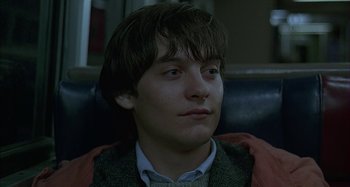Movie still from “The Ice Storm” (1997), directed by Ang Lee – A young man sitting in a chair with his head tilted to the side; Close Up shot, Low angle