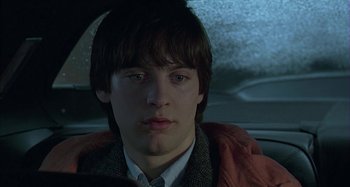 Movie still from “The Ice Storm” (1997), directed by Ang Lee – A man sitting in the back seat of a car; Close Up shot, Low angle