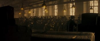 Movie still from “The Immigrant” (2013), directed by James Gray – A large group of people in a large room; Wide shot, High angle