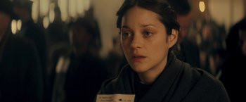 Movie still from “The Immigrant” (2013), directed by James Gray – A woman is looking down while holding a piece of paper in front of her face; Close Up shot, Over the shoulder angle